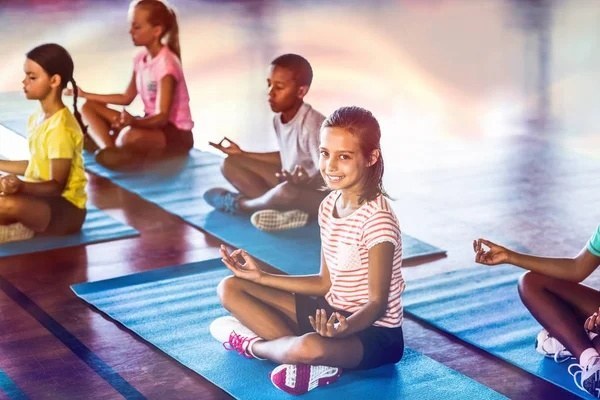 depositphotos_139562338-stock-photo-school-kids-meditating-during-yoga